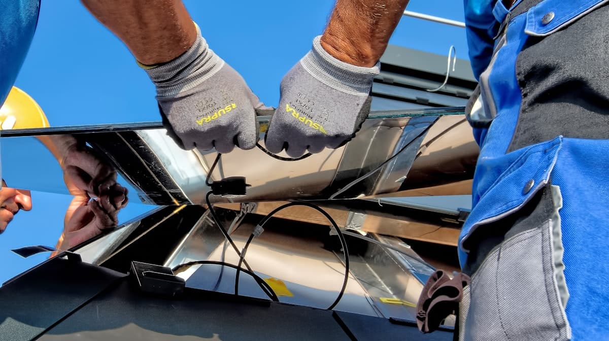 Technician securing a solar panel mount